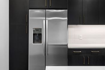 A stainless steel refrigerator with a water dispenser in a kitchen